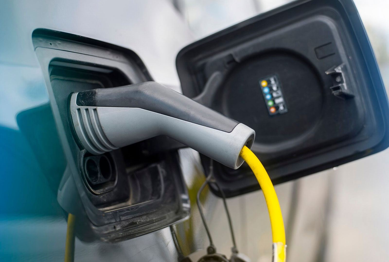 Close-up of a Type 2 connector and yellow lead plugged into a car