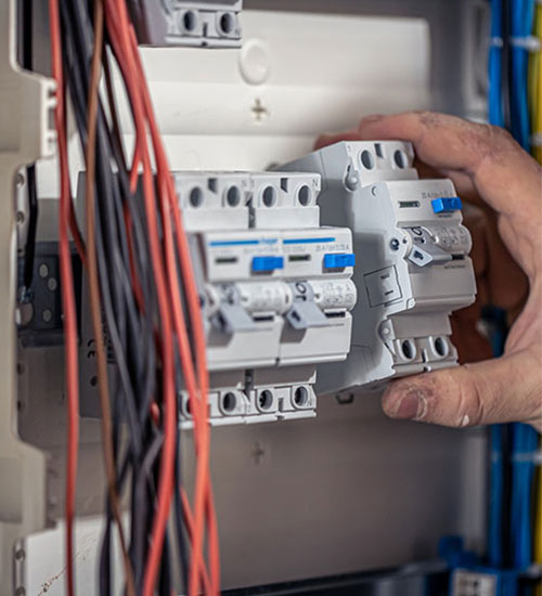 Hand fitting an RCD into a partly wired consumer unit