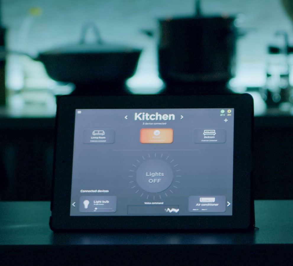 Tablet on a dark kitchen worktop running a smart lighting app