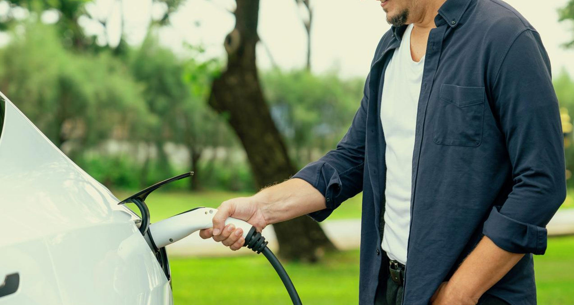 Charging cable being plugged into an electric car